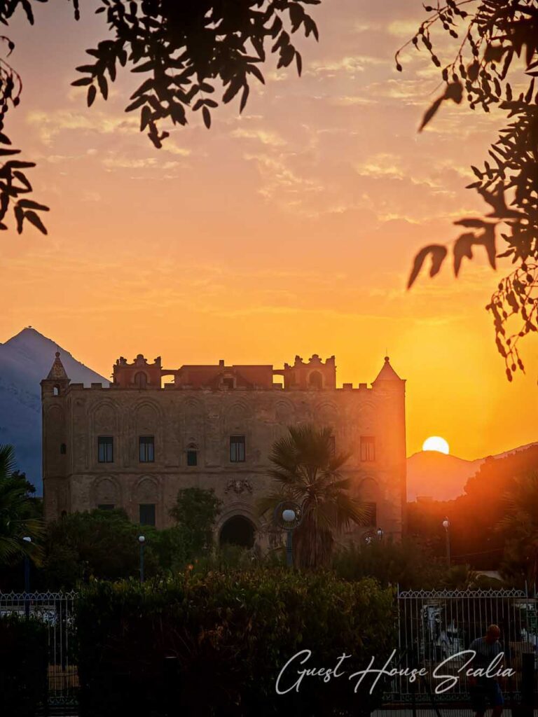 The Zisa Castle of Palermo 5 A glimpse of the Zisa Castle through the trees at sunset, a historic area for a holiday in Palermo.