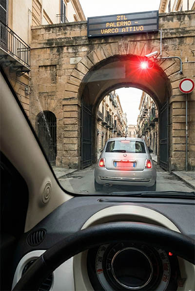 The Ultimate Guide to Palermo ZTL: Map, Times, Fines, and Where to Park 3 Car approaching the active Palermo ZTL gate with security camera issuing fines
